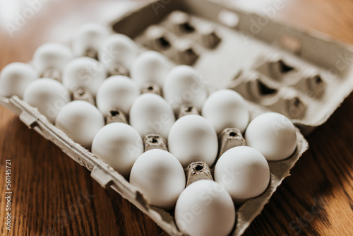 Close up of open carton of fresh store bought white eggs photo
