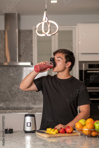 hispanic teenager preparing a smoothie on a blender