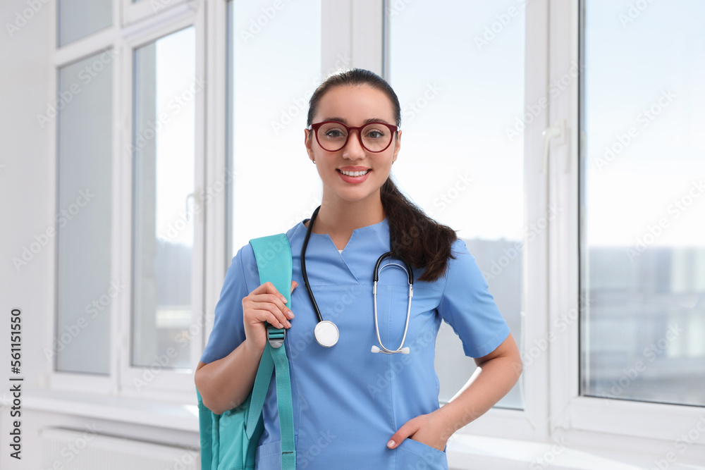 Smart medical student with stethoscope in college hallway Smart medical student with stethoscope in college hallway