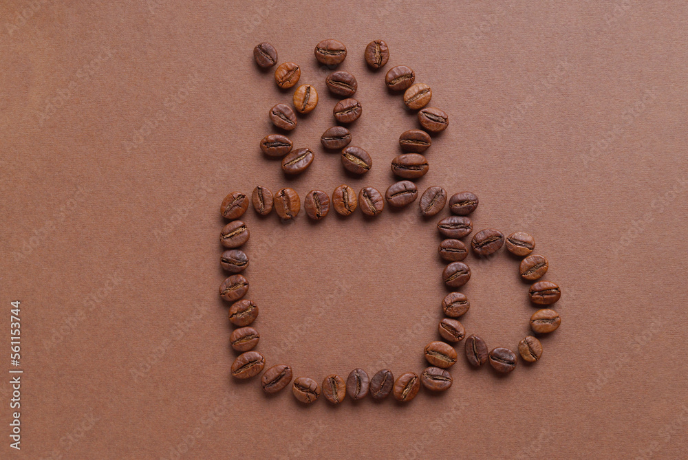 Cup of hot drink, composition made with coffee beans on brown background, flat lay Cup of hot drink, composition made with coffee beans on brown background, flat lay