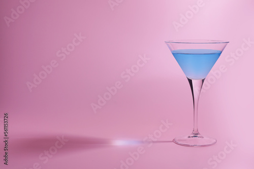 Martini glass with delicious cocktail on pink background, space for text
