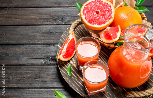 Grapefruit juice in a glass on tray.