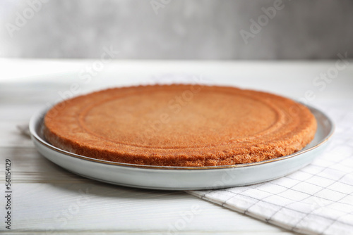 Delicious homemade sponge cake on white wooden table, closeup