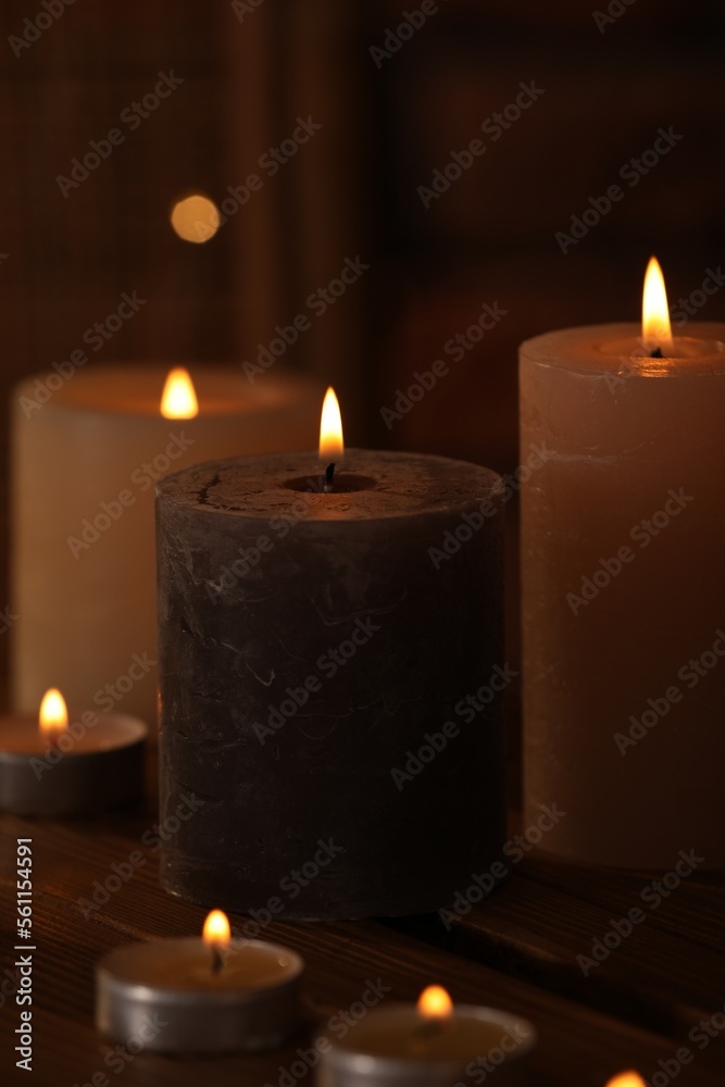 Spa composition with burning candles on wooden table in wellness center, closeup Spa composition with burning candles on wooden table in wellness center, closeup
