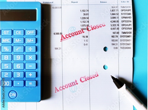 Calculator, pen, bank passbook stamp ACCOUNT CLOSED, concept of bank account was terminated or deactivated , withdraw to zero balance left , unable to do any transaction