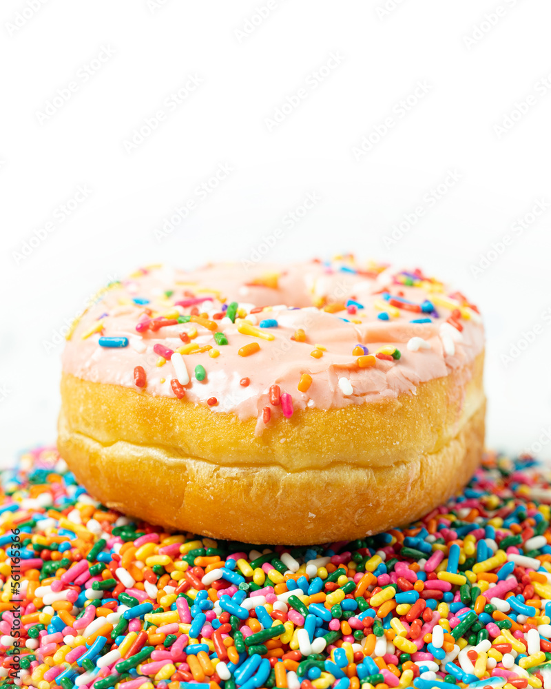 Pink Glazed Donut with Sprinkles on White Background Pink Glazed Donut with Sprinkles on White Background