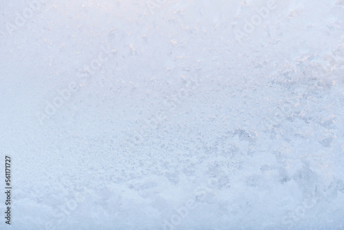 Frost ice patterns on a window glass. Rime on a windowpane, Bitter cold