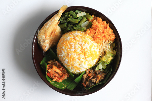 Nasi Jagung or Sego Jagung is traditional Indonesian food : rice cooked with dried corn, served with coconut vegetable salad, crunchy salted fish, and spicy sambal, isolated in white background.