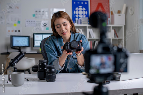Young Asian woman designer,photographer blogger influencer filming teaching camera tutorial while looking at camera shooting education tutorial vlog training filming video course for social media.