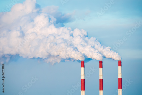 Coal power plant pipes with black smoke moving up polluting atmosphere. concept of environmental pollution.