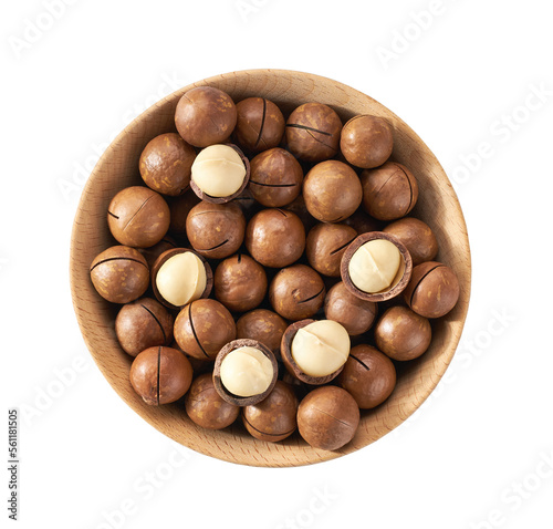 Macadamia in wooden bowl isolated on white background, top view.