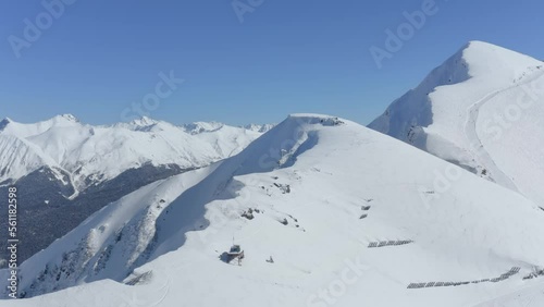 Ski winter resort mountain ridge peak landscape stone ridge snow skiing snowboarding slope track aerial view. Drone shot gazex system cinematic scenery alpine ecology environment active extreme sport photo