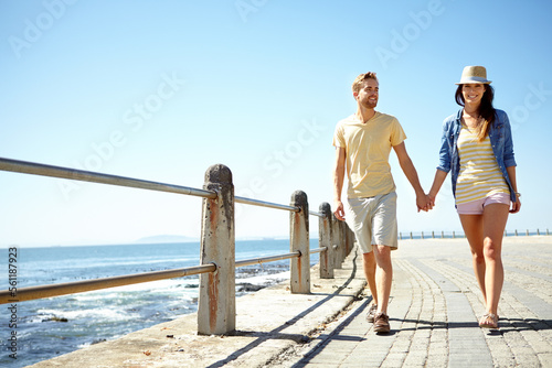 Fototapeta Naklejka Na Ścianę i Meble -  Beach, travel and happy couple holding hands while walking, talking and having fun on summer vacation. Sea, holiday and young man with woman bond, calm and happy, smile and relax together in Florida