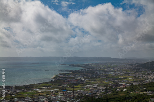 沖縄・中城城跡から見える空と海と街並み