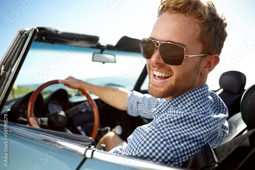 Car road trip, travel and portrait man on holiday adventure, happy transportation journey or fun summer vacation. Flare, sunglasses and driver driving convertible vehicle on Canada countryside tour