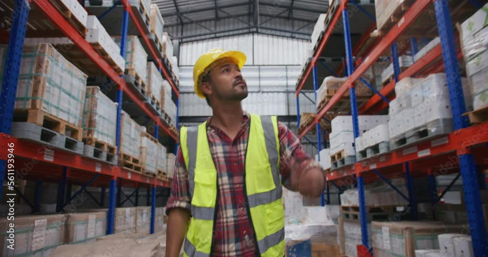 Portrait of a asian warehouse worker using digital tablet while looking at warehouse storage Portrait of a asian warehouse worker using digital tablet while looking at warehouse storage