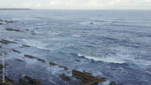 Drone aerial footage of the rugged and rocky coastline of Fitzmaurice Bay on King Island in
Australia photo