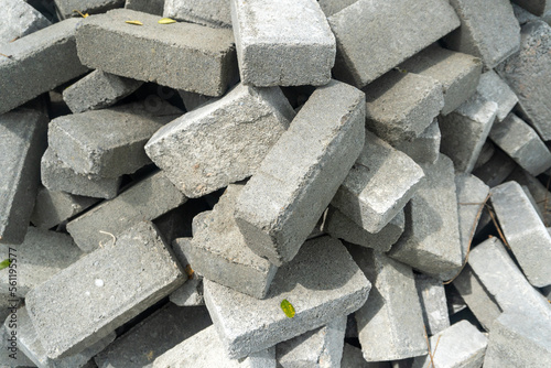 Fototapeta Naklejka Na Ścianę i Meble -  Pile of gray concrete bricks in the middle of a city park construction