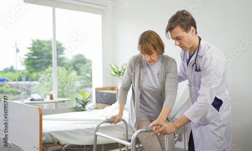 Portrait of caucasian doctor check up body of sick old senior elderly patient using walker, walking in hospital in medical and healthcare treatment at nursing home or clinic. People lifestyle