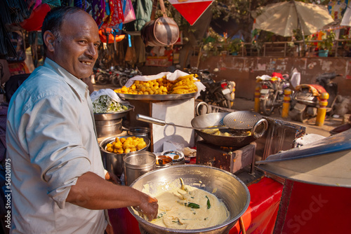 Male vendor making Mirchi Bajji at his roadside food stall photo