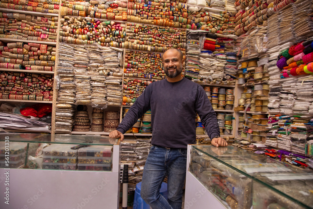Portrait of a cheerful male shop keeper standing at his lace shop Portrait of a cheerful male shop keeper standing at his lace shop