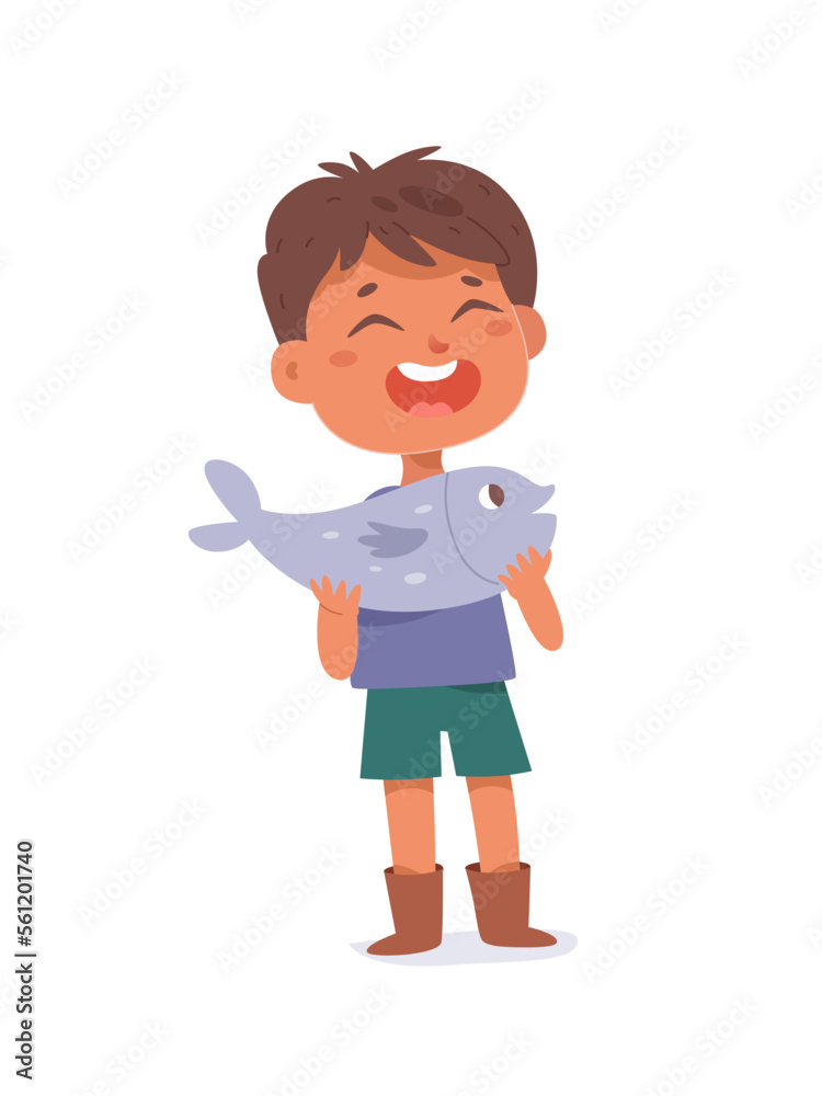 Happy boy holding fish, lucky little fisherman caught fish in water of summer river