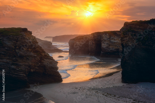 Cathedrals beach (Playa de las Catedrales) or Praia de Augas Santas at sunrise, amazing landscape with rocks on the Atlantic coast and colored sky, Ribadeo, Galicia, Spain. Outdoor travel background