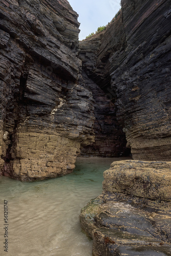 Bizarre natural rocks and caves of Cathedrals beach (Playa de las Catedrales) or Praia de Augas Santas at low tide, tourist attraction in Ribadeo, Galicia, Spain. Outdoor travel background