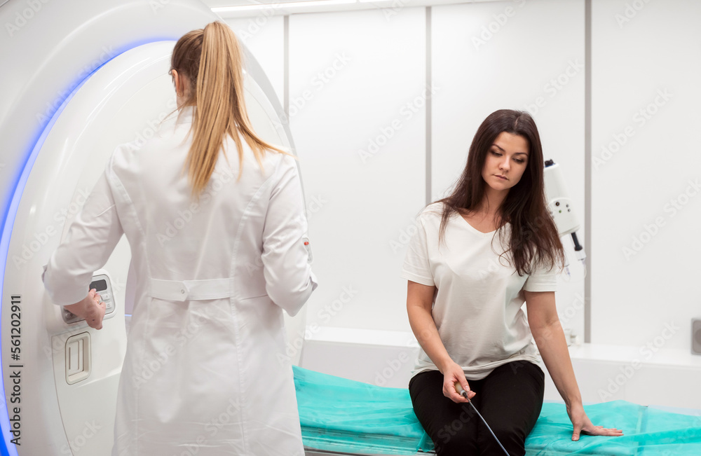 Obraz premium Medical CT or MRI Scan with a patient in the modern hospital laboratory. Interior of radiography department. Technologically advanced equipment in white room. Magnetic resonance diagnostics machine