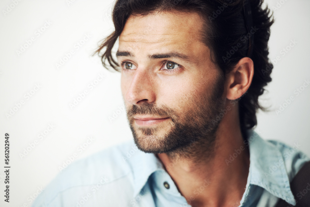 Obraz premium Face, thinking and inspiration with a handsome man on a gray background with blank mockup space. Idea, mock up and beard with a male posing to promote advertising, marketing or product placement