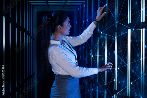 Female Technician/programmer working on the server in the data storage room photo