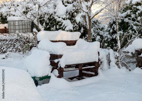 white winter landscape with garden attributes covered with snow  simple garden in winter under snow cover