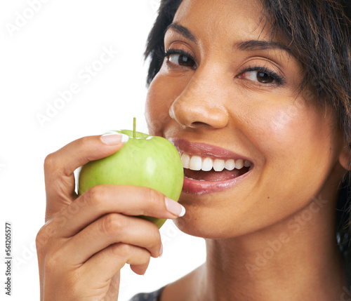 Apple, teeth and woman eating in studio for health, wellness and vegan diet with food or fruits promotion. Healthcare, self care and black woman with fruit choice for nutrition in a portrait smile photo