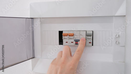 Turning on circuit breaker on control panel after it tripped due to overload photo