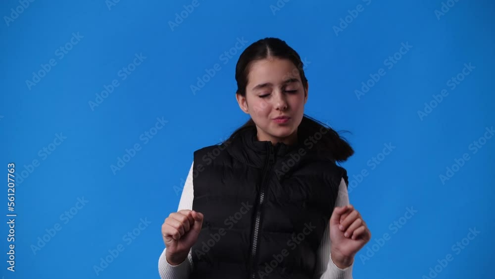 4k slow motion video of one girl dancing over blue background. 4k slow motion video of one girl dancing over blue background.