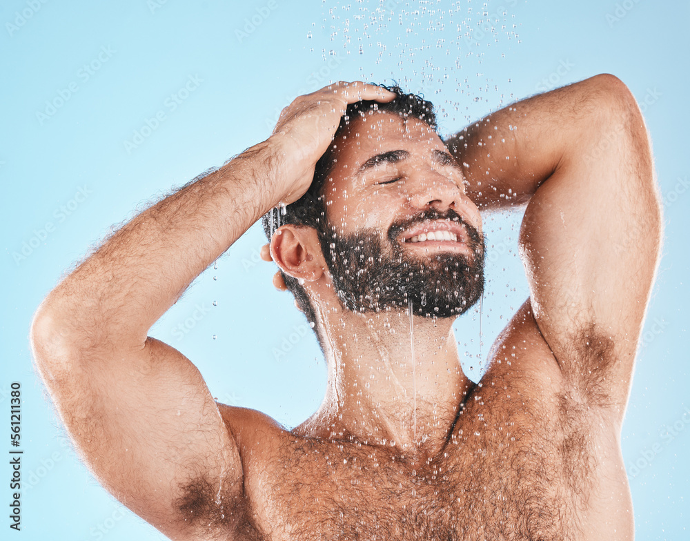 Shower, grooming and a man cleaning his hair with shampoo in studio on a blue background for beauty. Hygiene, washing and bathroom with a handsome male wet with liquid while bathing for haircare Shower, grooming and a man cleaning his hair with shampoo in studio on a blue background for beauty. Hygiene, washing and bathroom with a handsome male wet with liquid while bathing for haircare