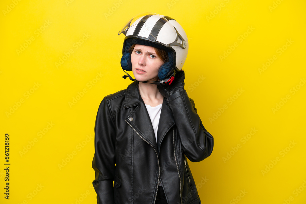 Fototapeta premium Young English woman with a motorcycle helmet isolated on yellow background having doubts