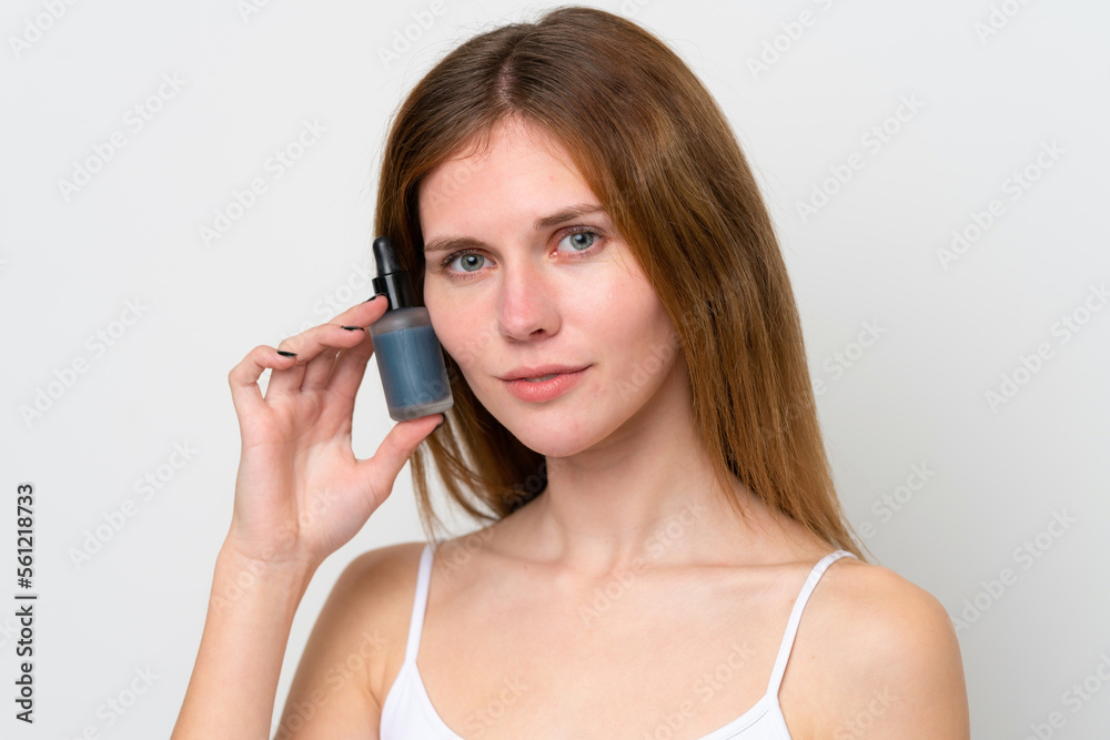 Young English woman holding a serum. Close up portrait Young English woman holding a serum. Close up portrait