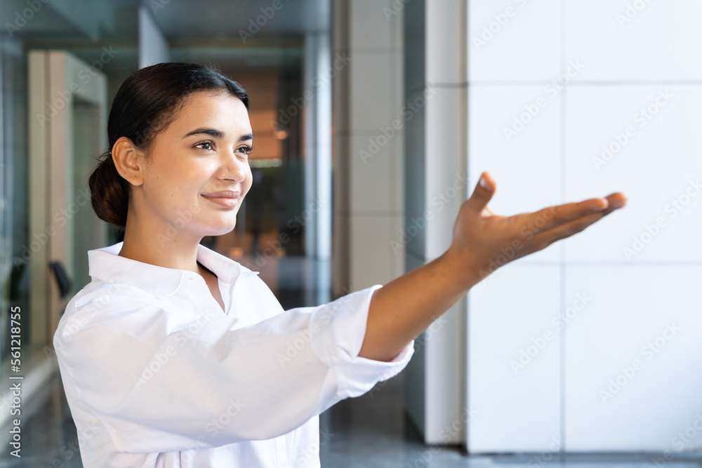 Happy south asian woman pointing her hand up to blank space Happy south asian woman pointing her hand up to blank space