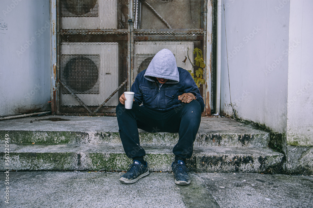 Sad homeless man begs for money at the street Sad homeless man begs for money at the street