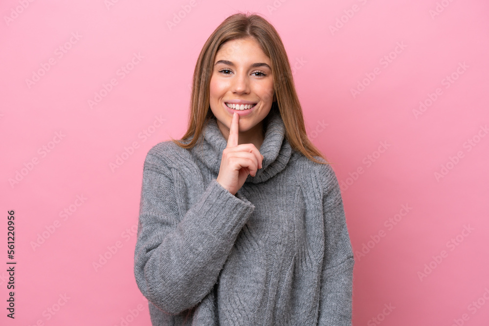 Young caucasian woman isolated on pink bakcground showing a sign of silence gesture putting finger in mouth Young caucasian woman isolated on pink bakcground showing a sign of silence gesture putting finger in mouth