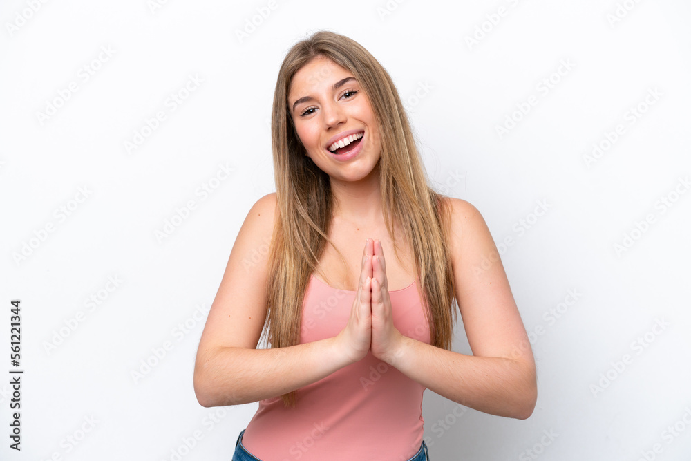 Young caucasian woman isolated on white bakcground keeps palm together. Person asks for something Young caucasian woman isolated on white bakcground keeps palm together. Person asks for something