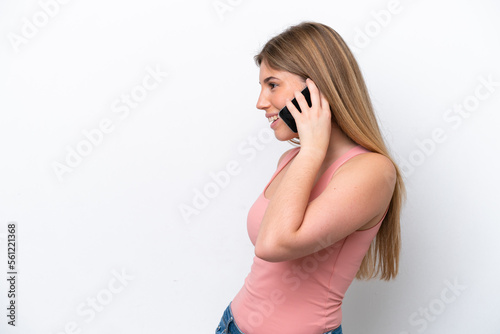 Young caucasian woman isolated on white bakcground keeping a conversation with the mobile phone with someone