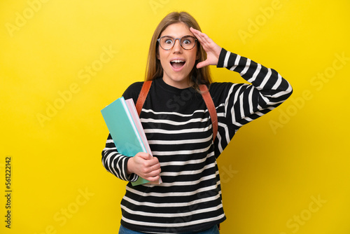 Young student woman isolated on yellow background background with surprise expression