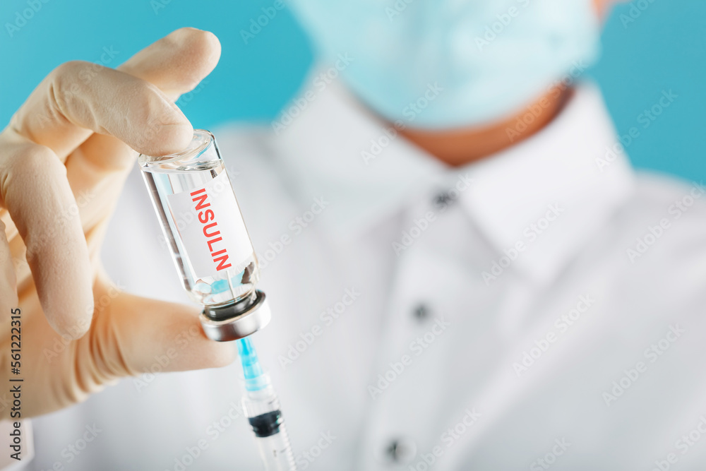 Diabetes treatment a bottle of insulin and a syringe with a needle in the hands of a doctor Diabetes treatment a bottle of insulin and a syringe with a needle in the hands of a doctor