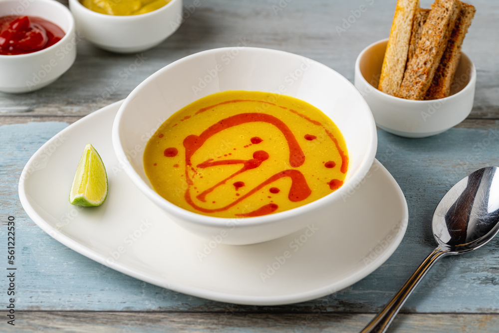 Strained lentil soup on a white porcelain plate Strained lentil soup on a white porcelain plate