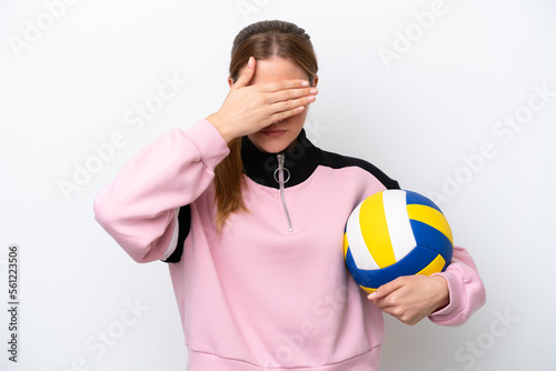 Young caucasian woman playing volleyball isolated on white background covering eyes by hands. Do not want to see something