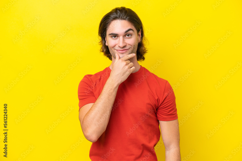 Caucasian handsome man isolated on yellow background thinking Caucasian handsome man isolated on yellow background thinking