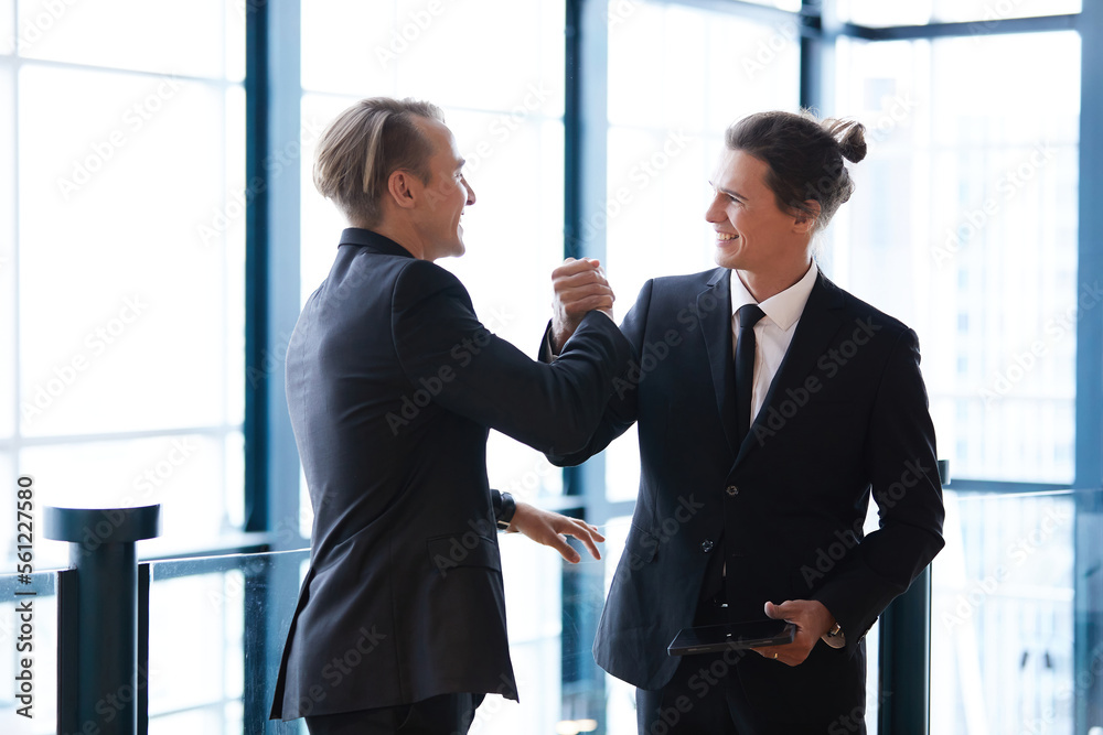 businessman shaking hands with friends and having fun in the office businessman shaking hands with friends and having fun in the office