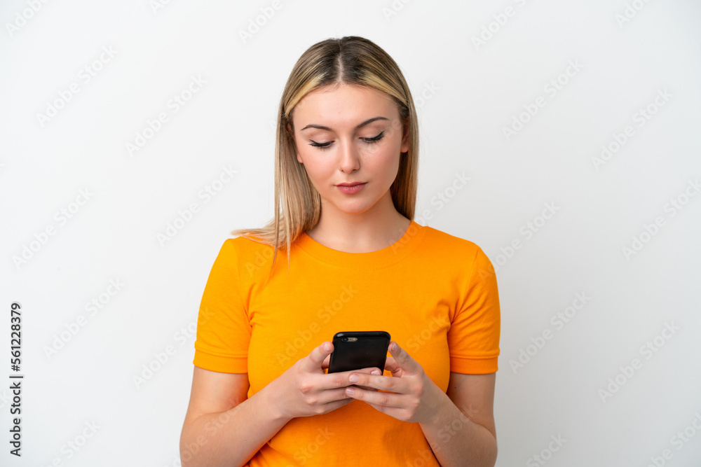 Young caucasian woman isolated on white background using mobile phone Young caucasian woman isolated on white background using mobile phone